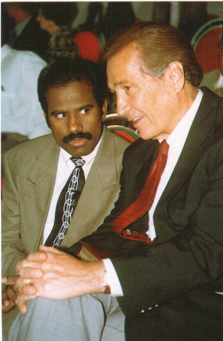 Dr. K.A. Paul in conversation with a statesman at a conference