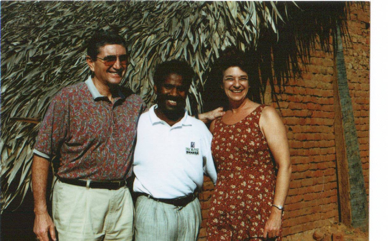 Dr. K.A. Paul with missionaries outside a thatched village home in Africa